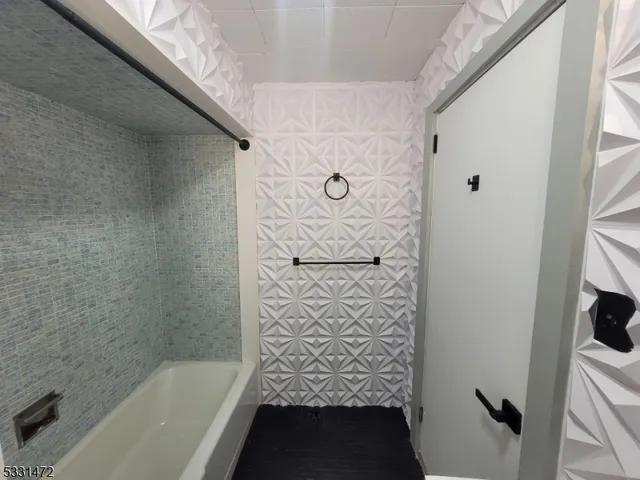 a bathroom with a bathtub and shower