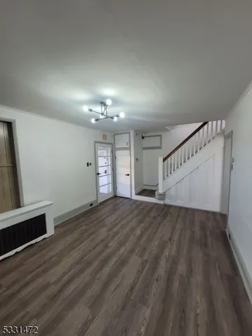 wooden floor in an empty room with a fireplace
