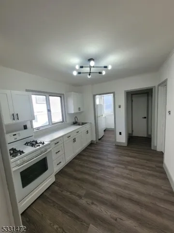 a view of a kitchen with a stove cabinets and wooden floor