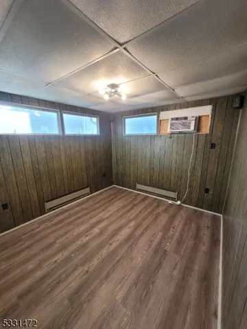 a view of empty room with wooden walls