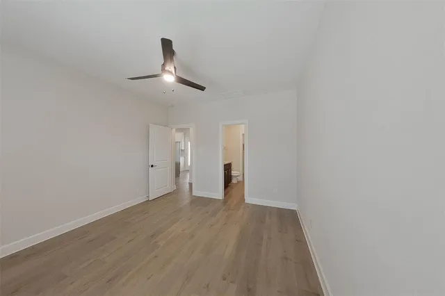a view of an empty room and wooden floor