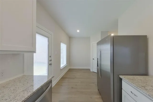 a bathroom with a granite countertop sink and shower