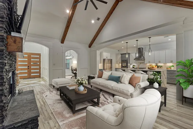 a living room with furniture kitchen view and a large window
