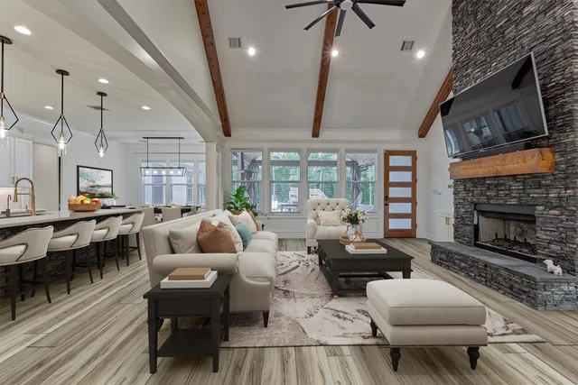 a living room with furniture fireplace and a table