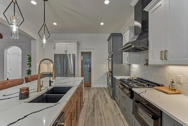 a kitchen with granite countertop a stove and a sink