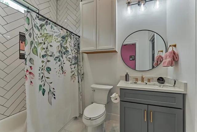 a bathroom with a sink toilet and mirror