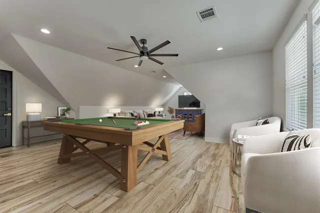 a living room with furniture a clock and wooden floor