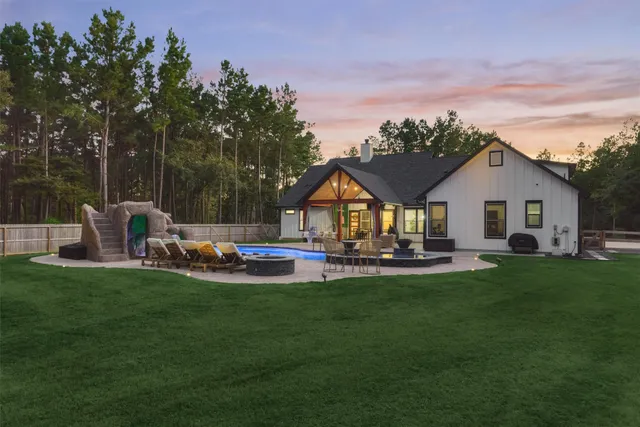 a aerial view of a house with swimming pool and sitting area