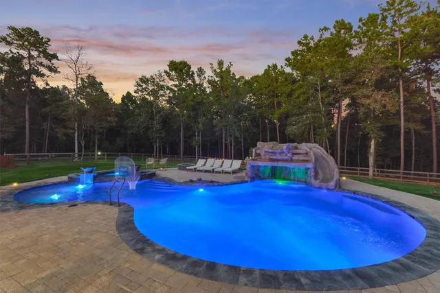 a view of a swimming pool with chairs