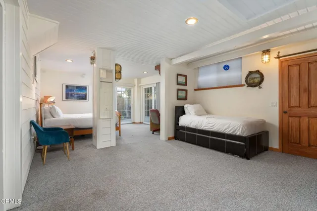 a spacious bedroom with a bed and a table in it