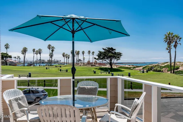 a view of a table and chairs under an umbrella