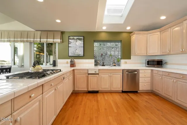 a kitchen with a sink window and cabinets