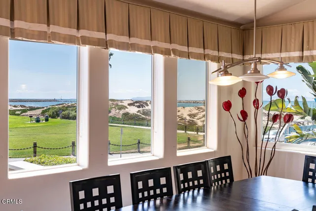 a kitchen with stainless steel appliances a stove a refrigerator a sink and a window