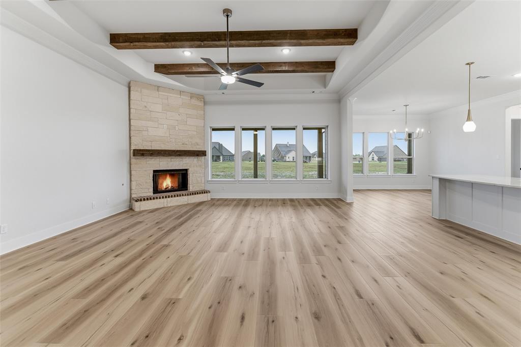 2208 Continent Court Krum, TX 76249 - Photo 10 of 26 Spacious open-concept interior featuring light wood-finish flooring and numerous windows