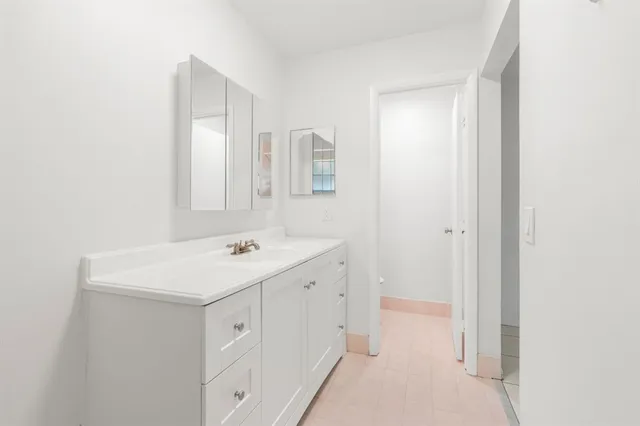 a utility room with cabinets washer and dryer