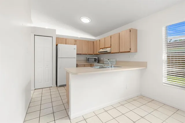 a kitchen with stainless steel appliances a refrigerator sink and cabinets