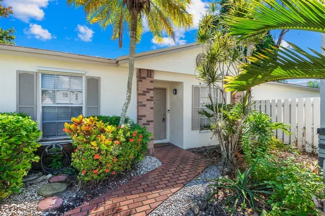 a house with a flower garden in front of it