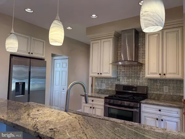 a kitchen with stainless steel appliances granite countertop a stove and a sink