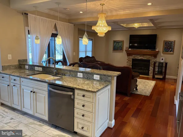 a kitchen with sink cabinets and wooden floor