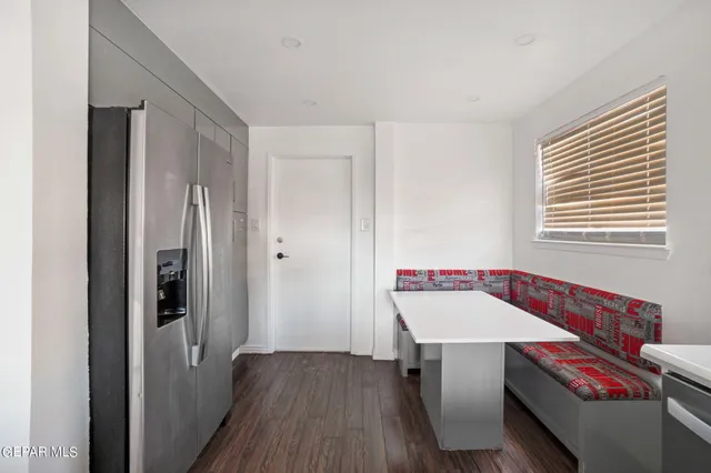 a kitchen with a sink cabinets and wooden floor
