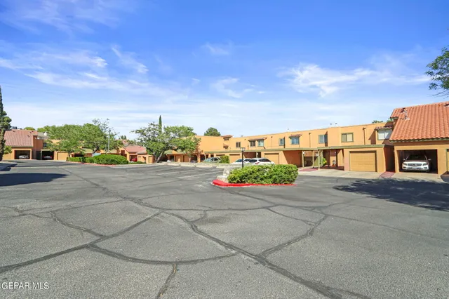 a couple of cars parked in front of a house
