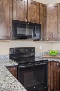 a stove top oven sitting inside of a kitchen
