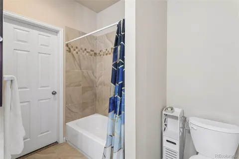 a bathroom with a shower and toilet
