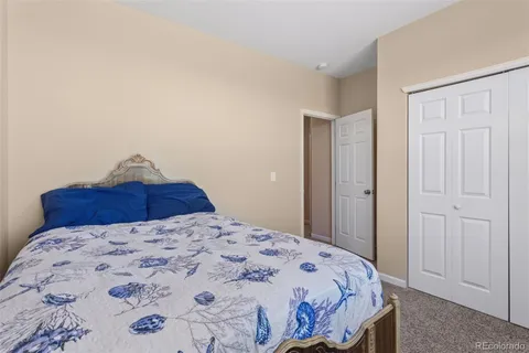 a bedroom with a large bed and a chandelier