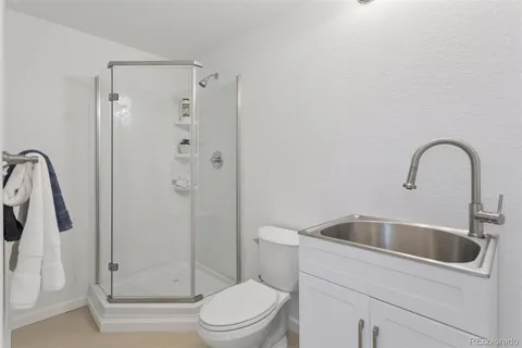 a bathroom with a toilet sink and shower