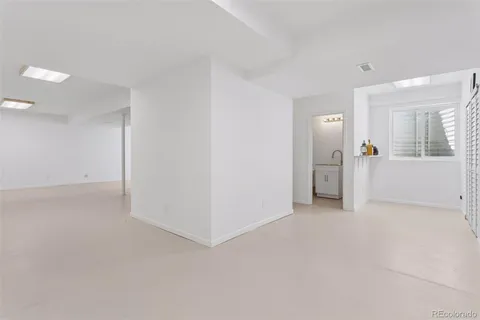 an empty room with closet and mirror