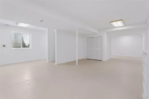 an empty room with a empty space and windows