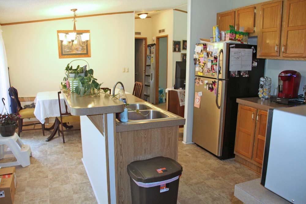 2445 Rutrough Road Southeast Roanoke, VA 24014 - Photo 3 of 23 a kitchen that has a refrigerator and a table in it