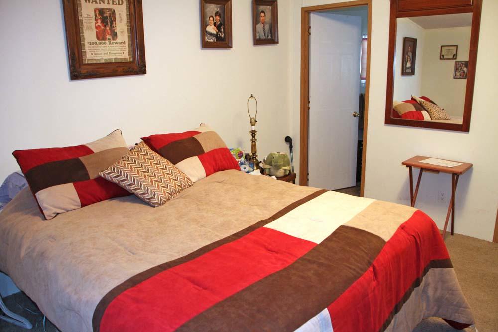 2445 Rutrough Road Southeast Roanoke, VA 24014 - Photo 4 of 23 a bedroom with a bed and a chair