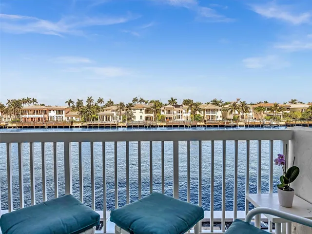 a balcony with a bench and city view