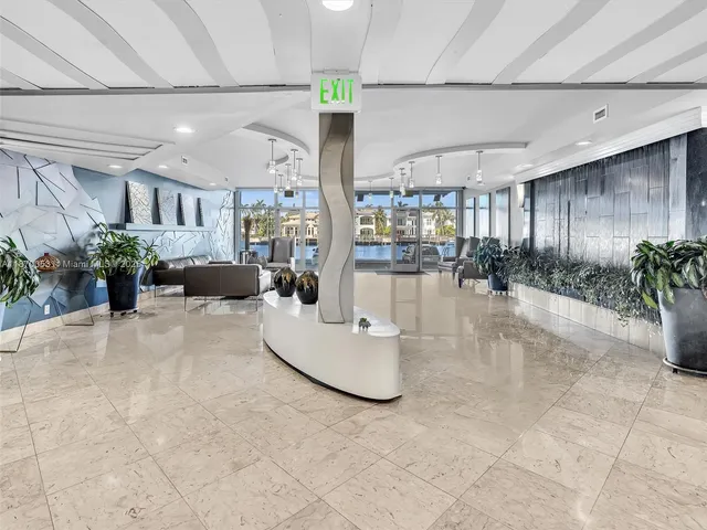 a gym room with lots of furniture and a chandelier