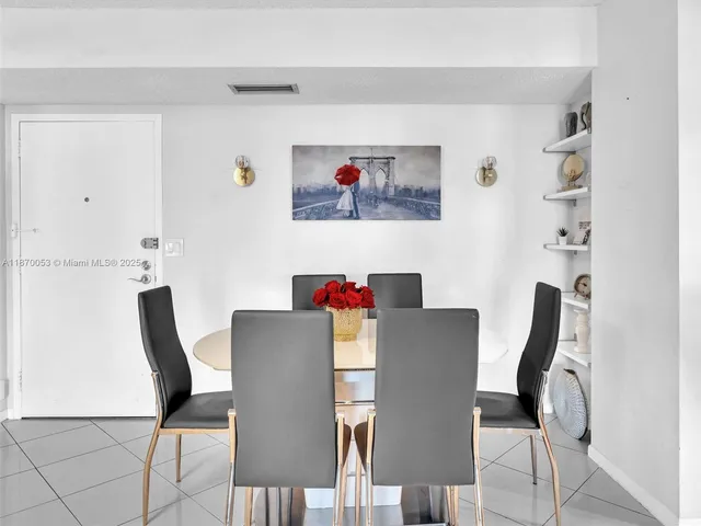 a view of a dining room with furniture and a potted plant