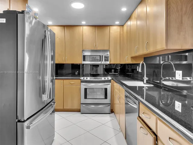 a kitchen with a sink cabinets and stainless steel appliances