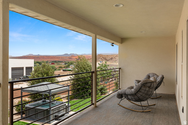 2591 East Washington Dam Road Washington, UT 84780 - Photo 9 of 67 Covered balcony with tile flooring and a black metal railing