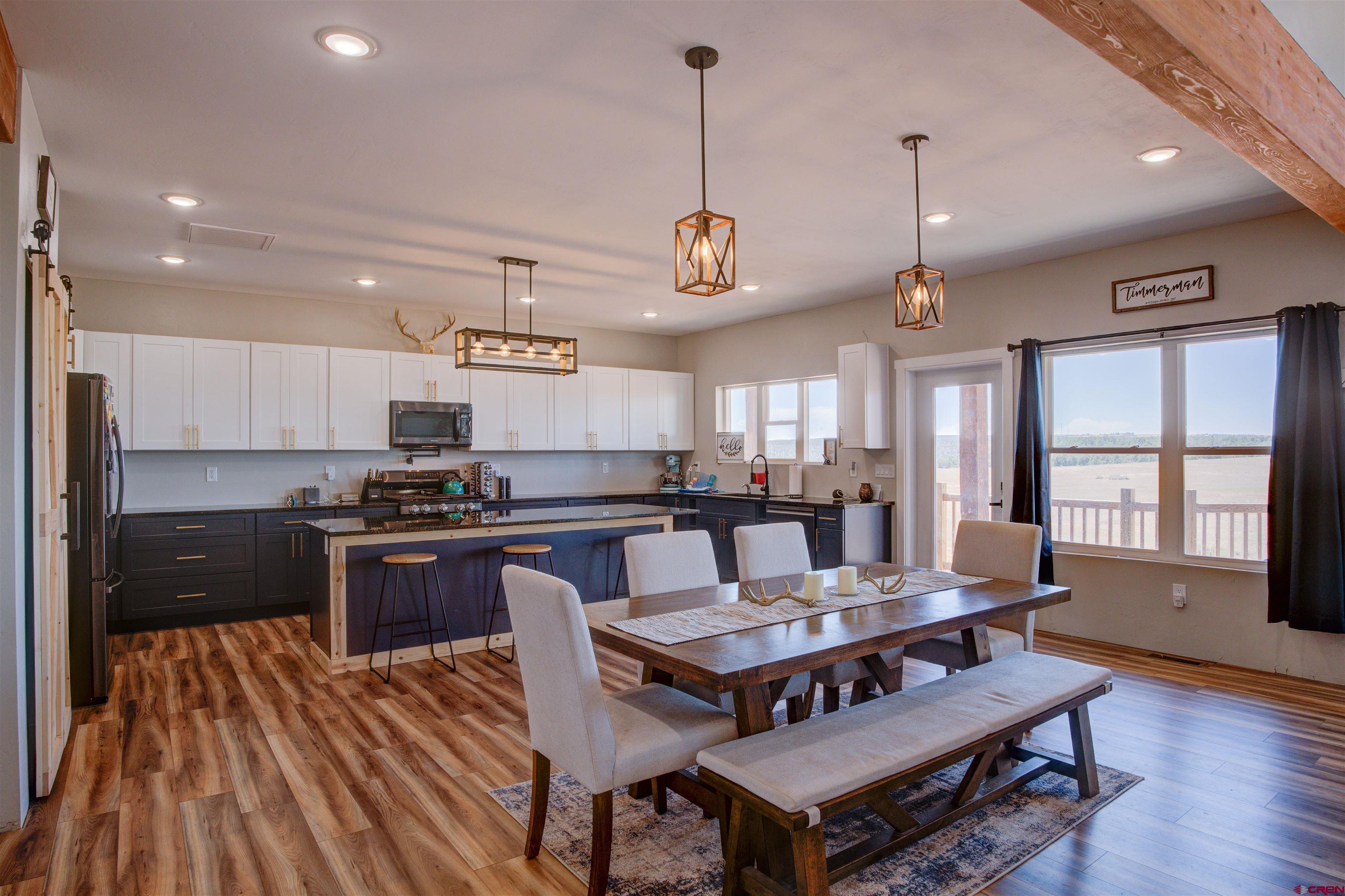 13205 Road 17.9 Loop Cortez, CO 81321 - Photo 15 of 35 a view of a dining room with furniture window and wooden floor
