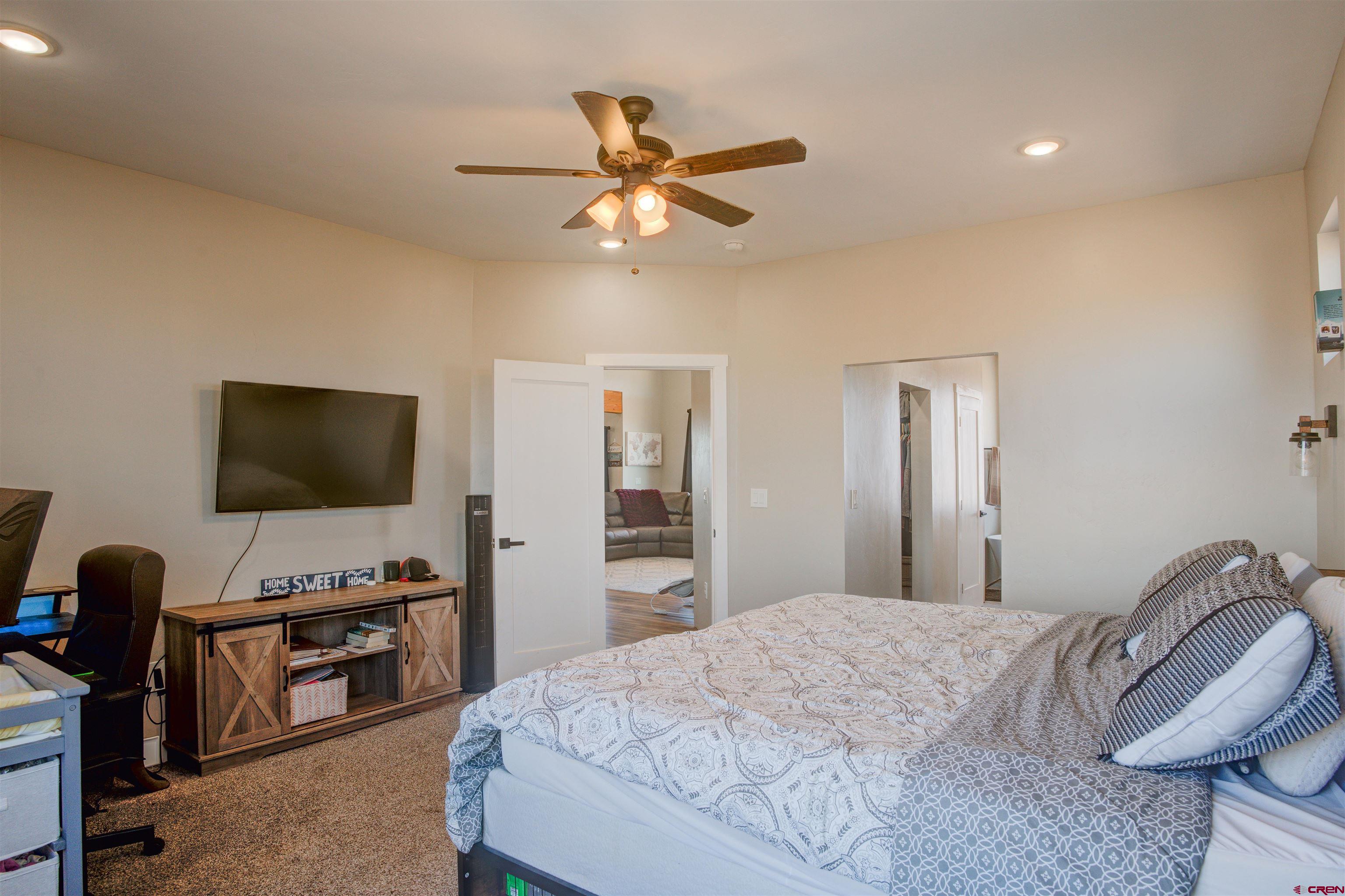 13205 Road 17.9 Loop Cortez, CO 81321 - Photo 19 of 35 a bedroom with a bed and a flat screen tv