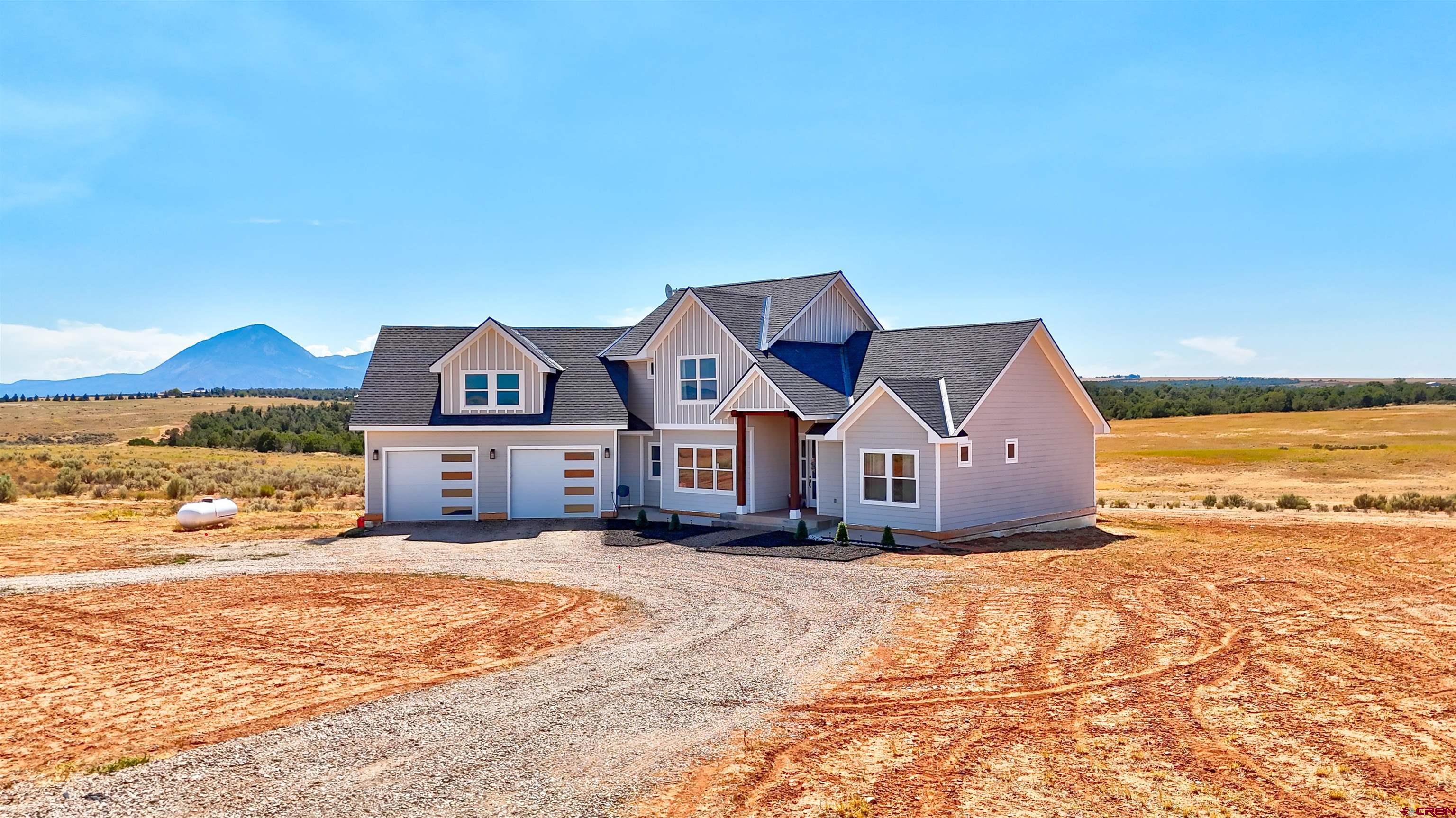 13205 Road 17.9 Loop Cortez, CO 81321 - Photo 2 of 35 a view of a house with a big yard and large trees