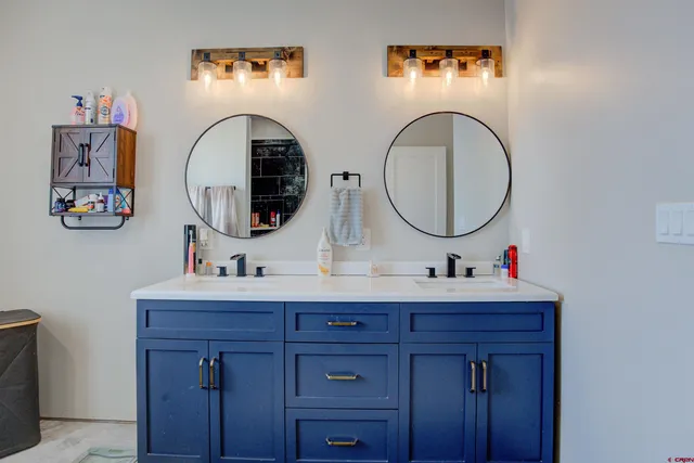 a bathroom with 2 sink and a mirror