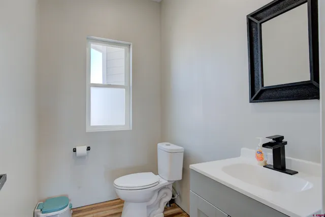 a bathroom with a toilet sink and mirror