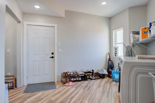 a view of a storage & utility room with two washing machine
