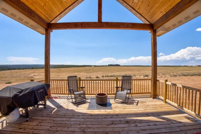 a view of a balcony with lake view and wooden floor
