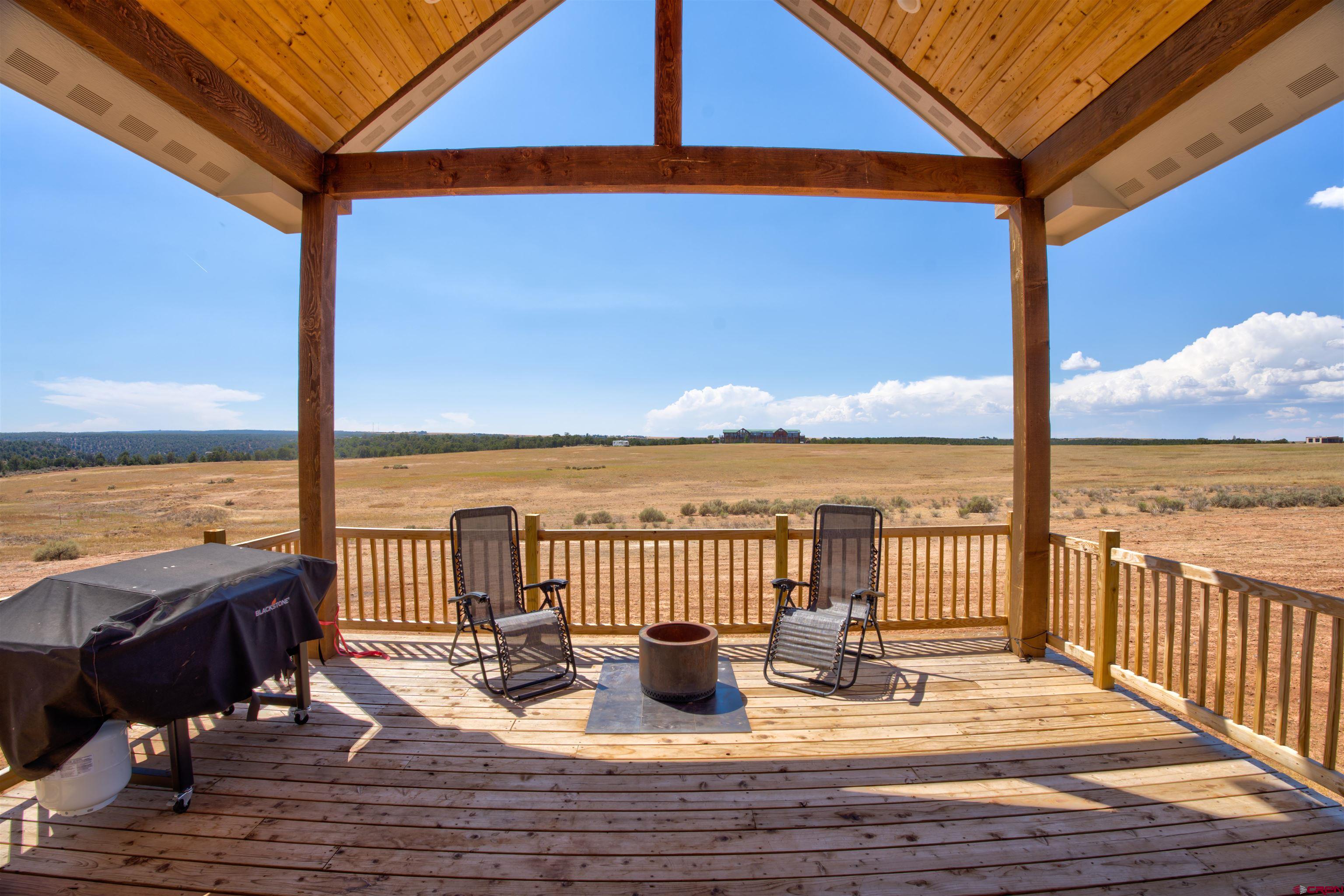 13205 Road 17.9 Loop Cortez, CO 81321 - Photo 7 of 35 a view of a balcony with lake view and wooden floor