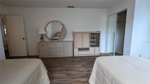 a bedroom with a bed and a dresser