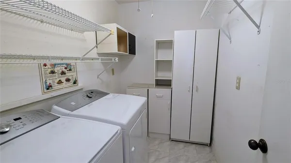 a bed room with a bed and a chair