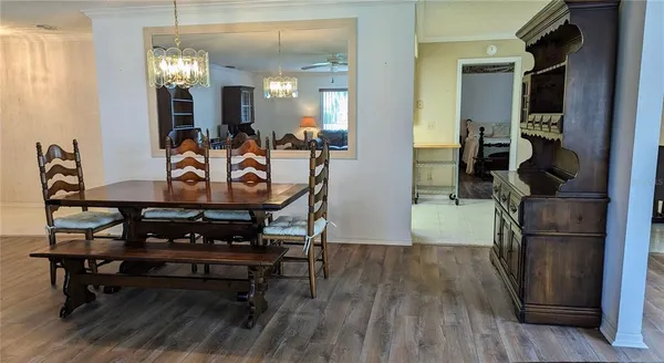 a bedroom with two beds and a chandelier