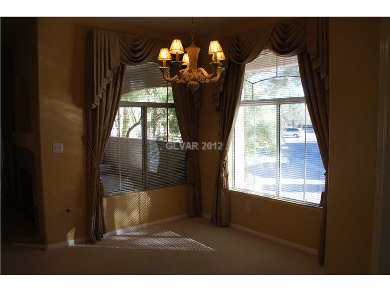 2050 West Warm Springs Road, Unit 3921 Henderson, NV 89014 - Photo 4 of 12 Dining Room. Dining room has custom draperies and chandelier.
